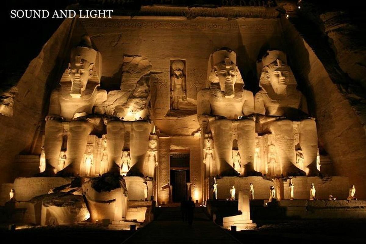 a building with a bunch of statues on it at night