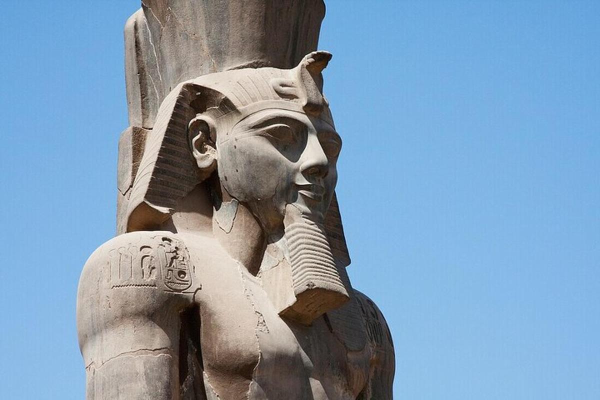a statue of anubis holding a spear on a pole