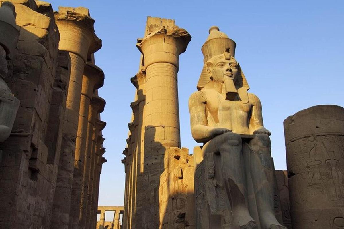 a statue in front of some ruins