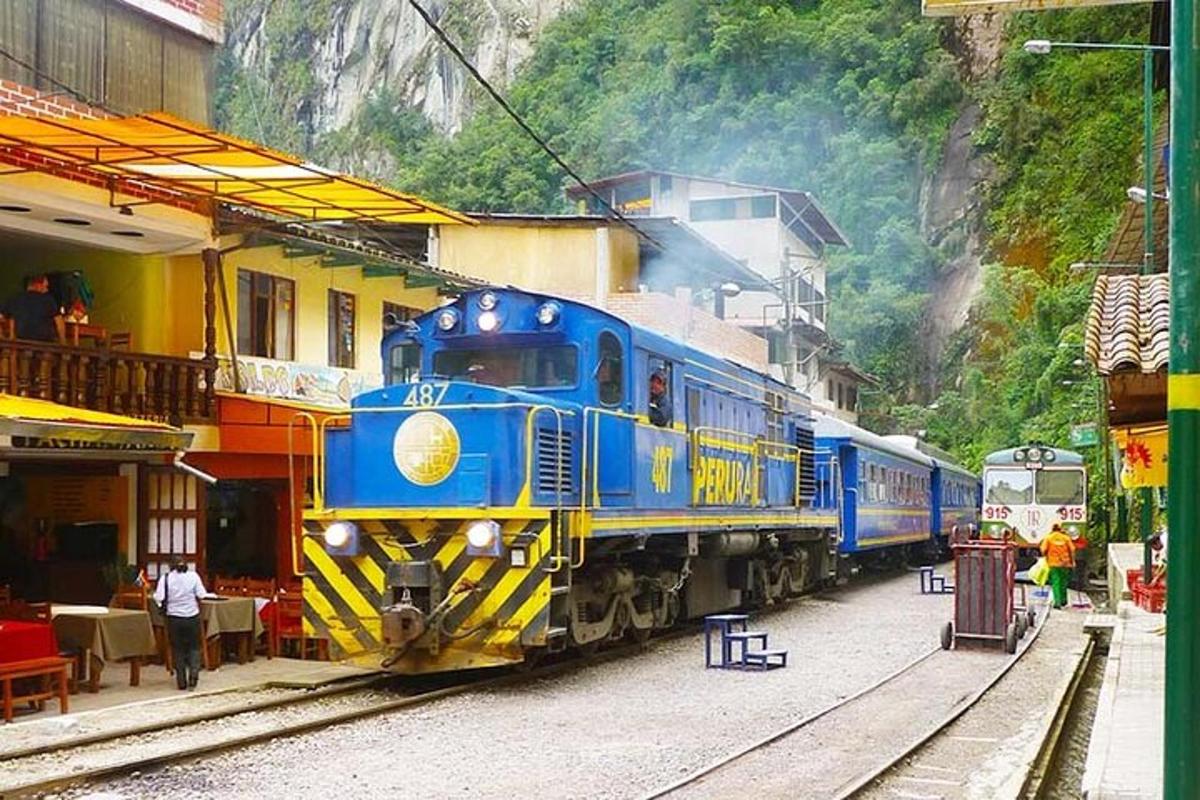 a blue and yellow train parked at a train station