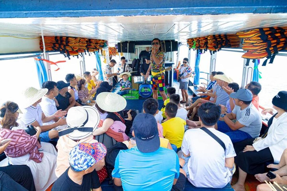 a group of people on a boat with a man on a stage