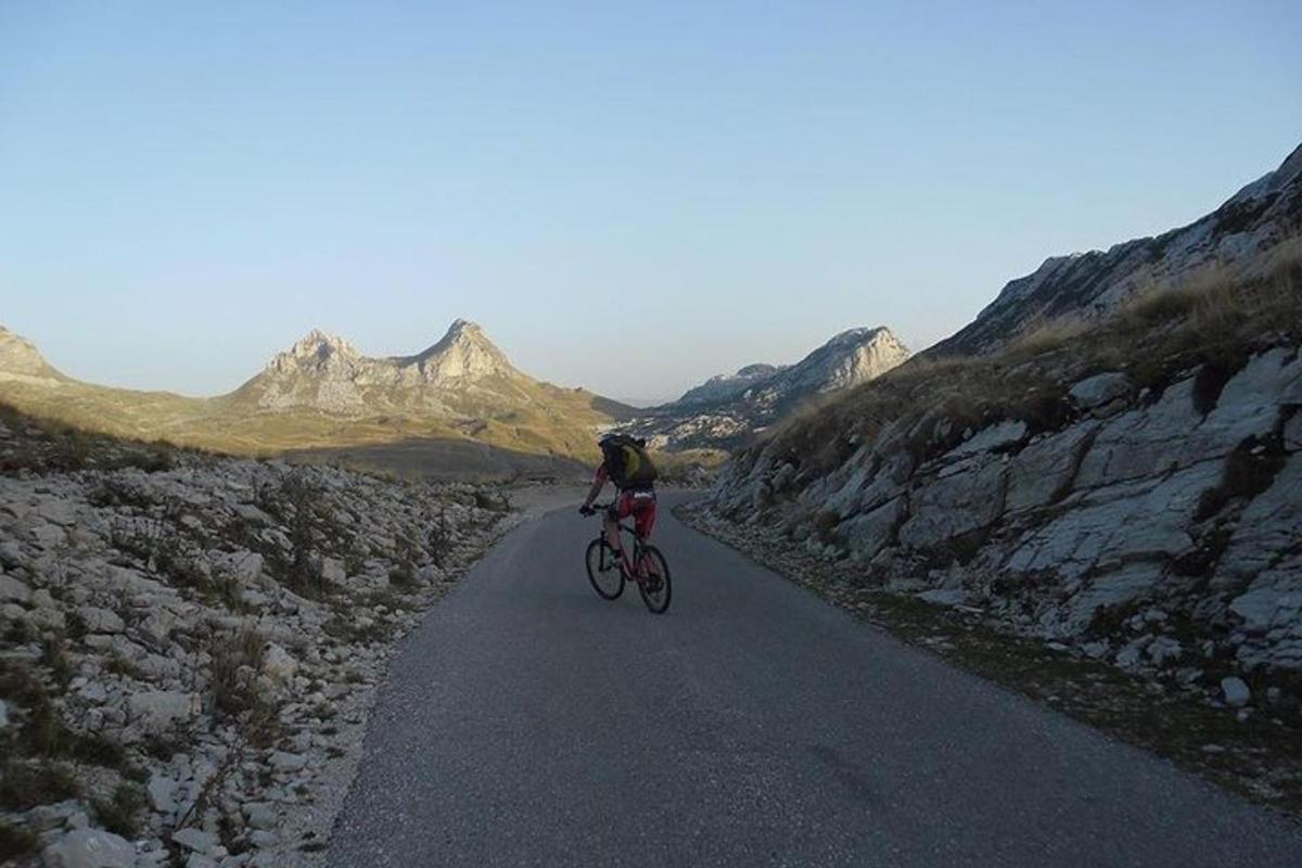 a person riding a bike down a road