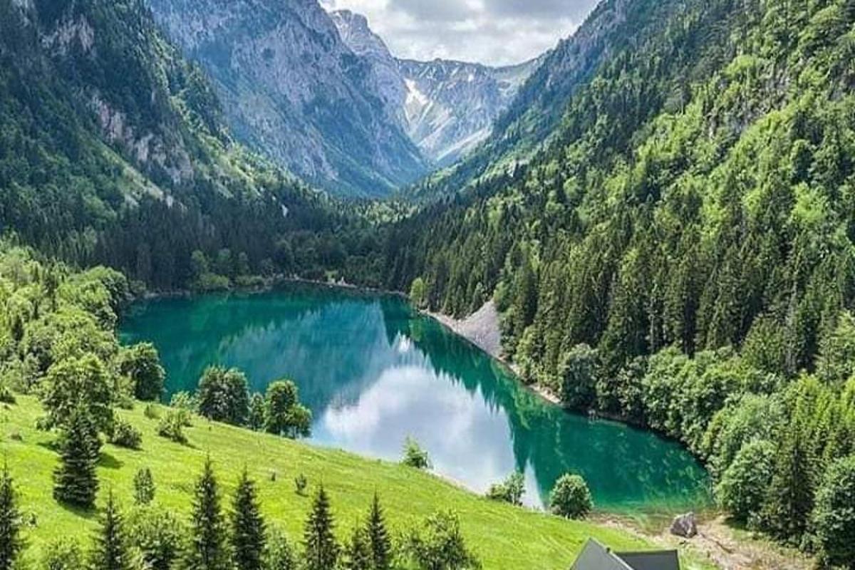 a lake in the middle of a green valley