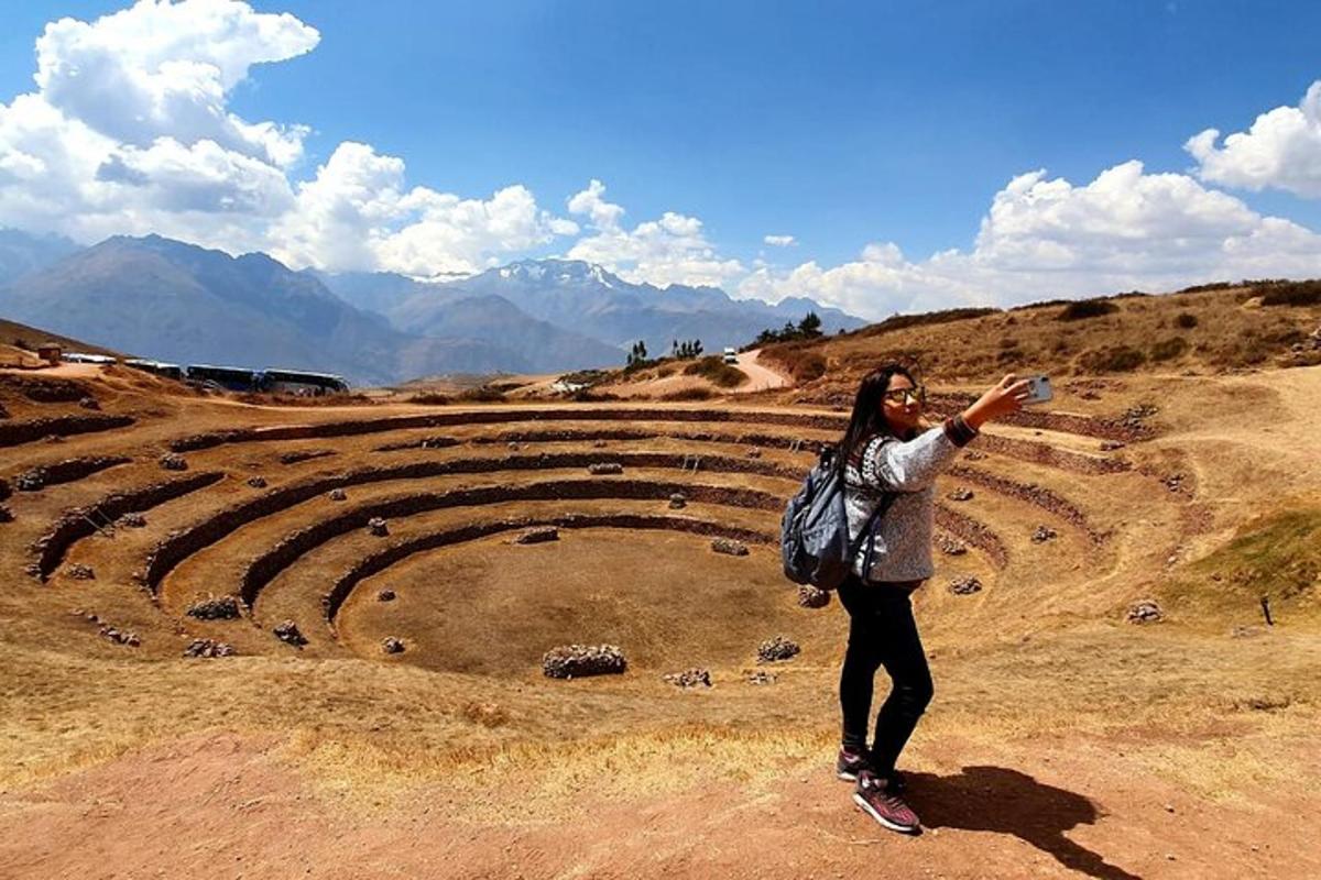 a woman taking a picture of an amphitheater