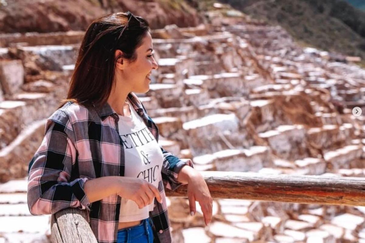 a woman is looking at the view of a mountain