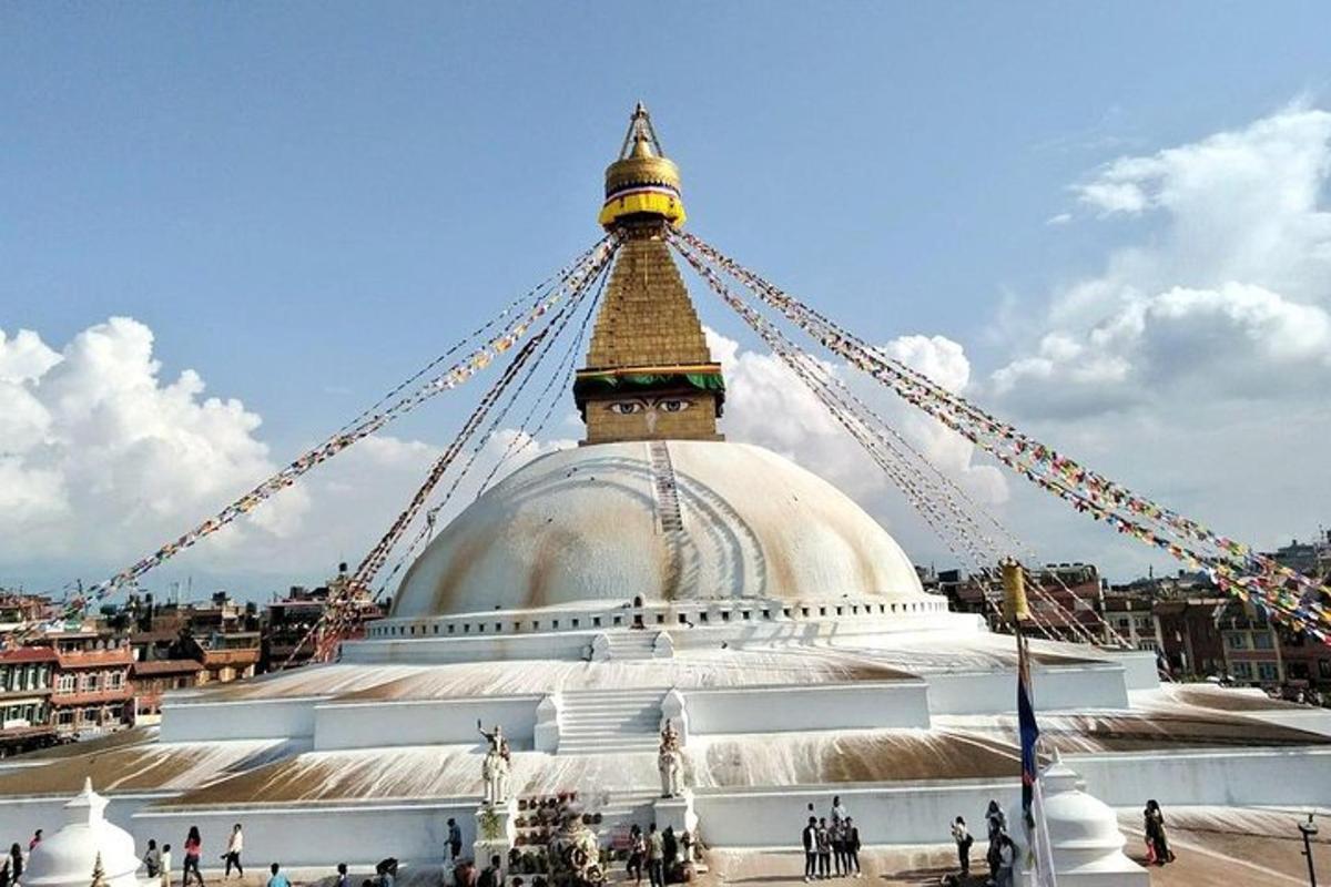 a large white temple with a gold top