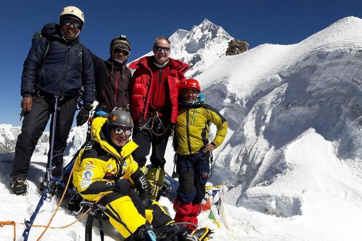 a group of people standing on top of a mountain