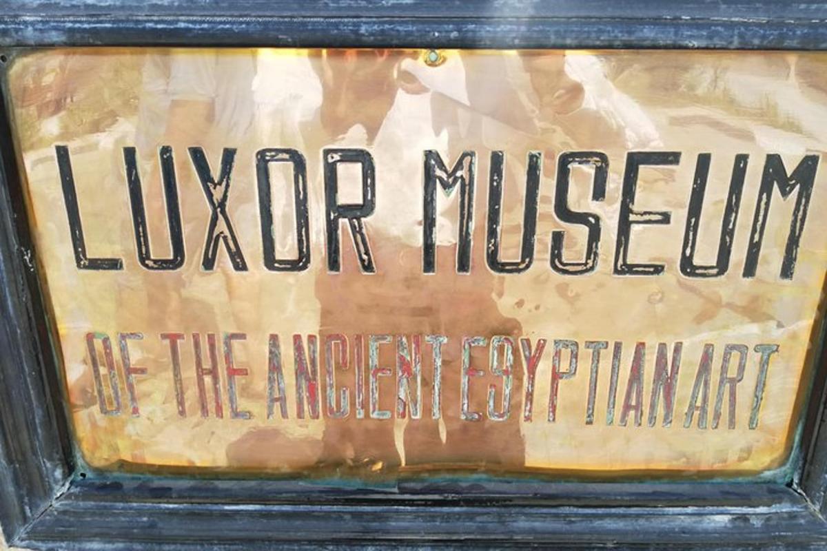 a sign for a museum in a black frame
