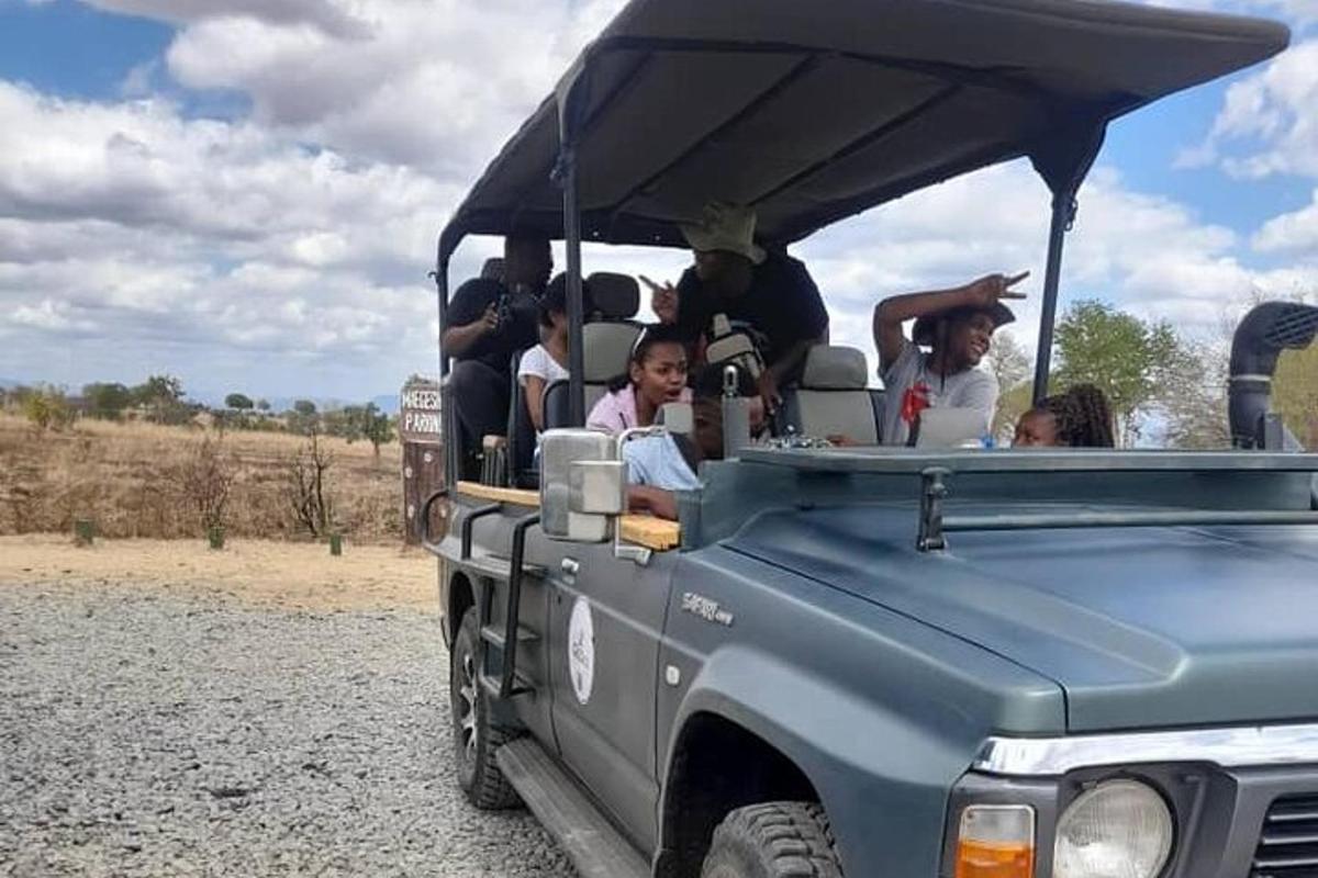 a group of people riding in the back of a jeep