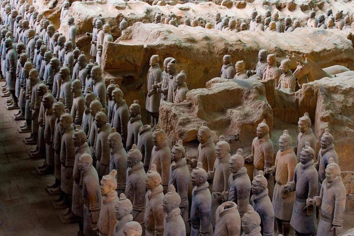 a large group of statues on a wall