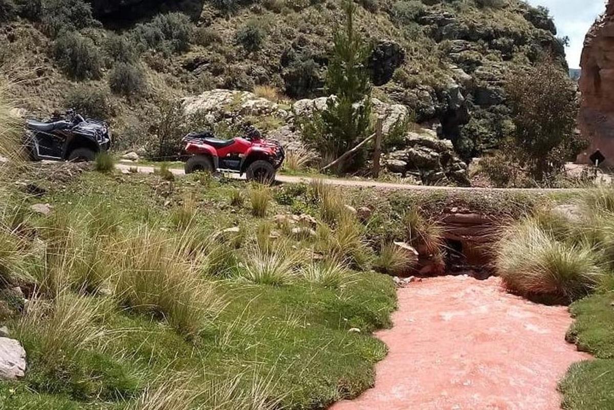 a red atv parked on the side of a road