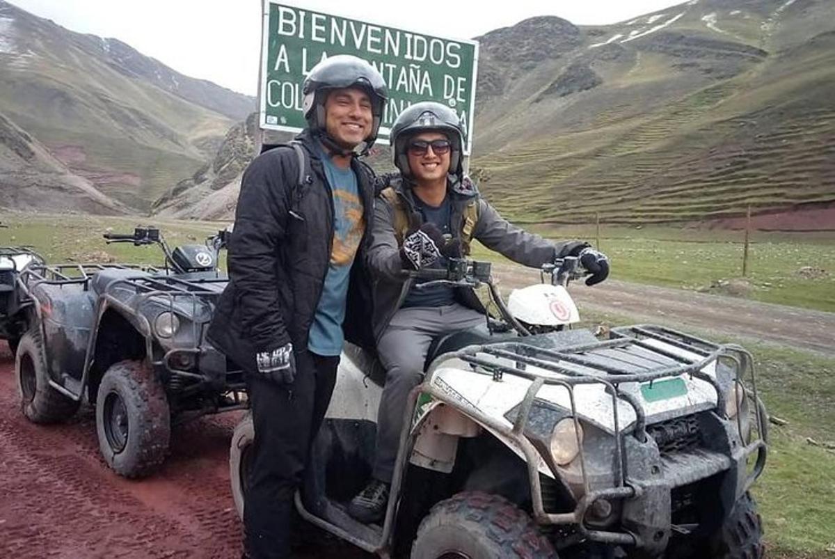 a man and a woman standing next to an atv