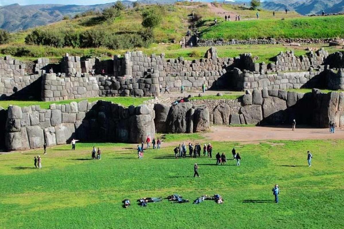 a group of people standing in a field with rocks