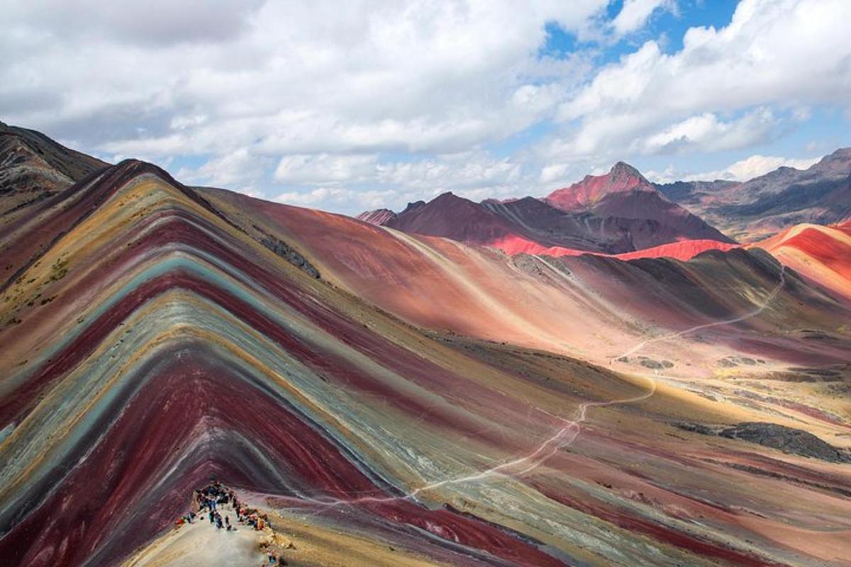 a painting of a desert with mountains in the background