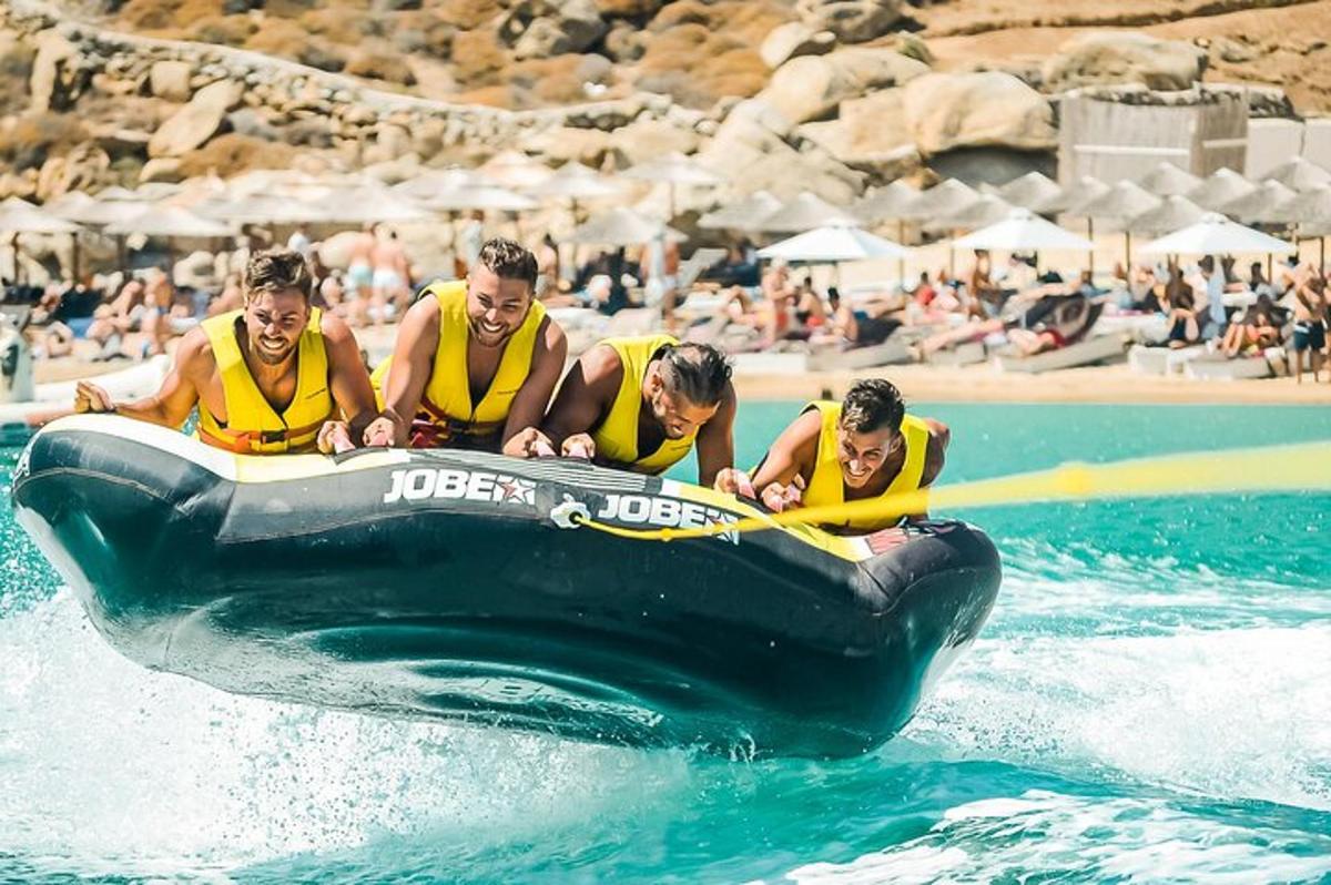 a group of men in yellow life jackets on a raft in the water