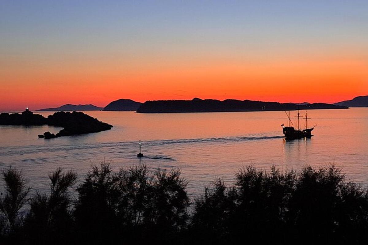 a boat is in the water at sunset