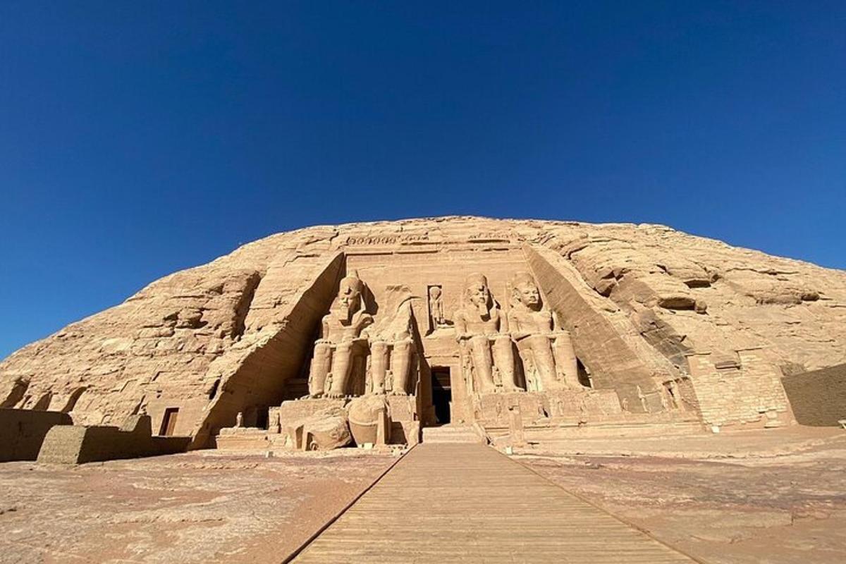 a large building in the desert with a blue sky