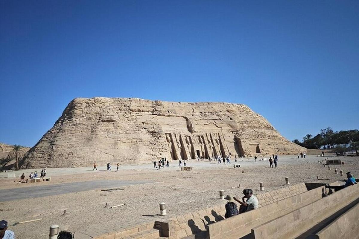 a group of people standing in front of a pyramid