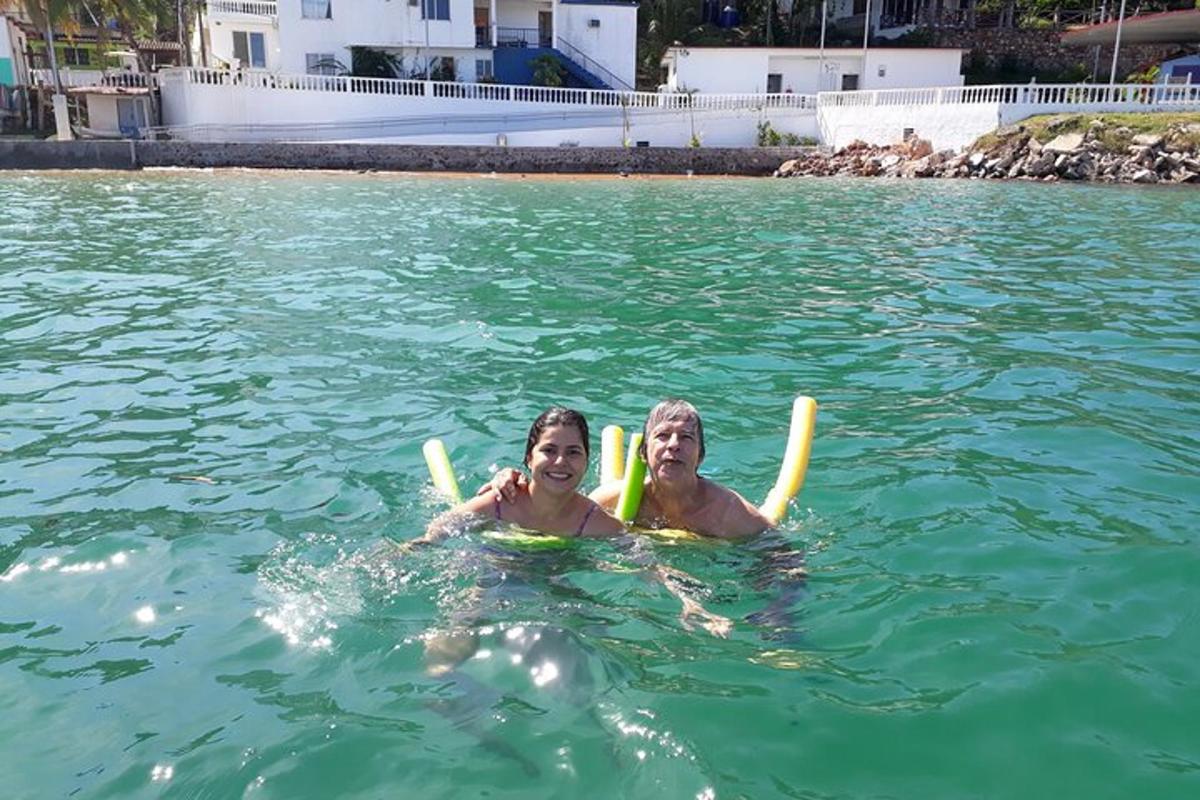 two people are swimming in the water