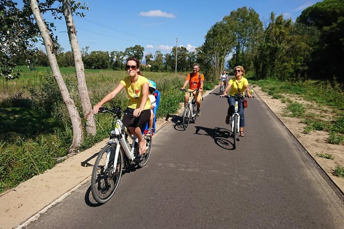 a group of people riding bikes down a road