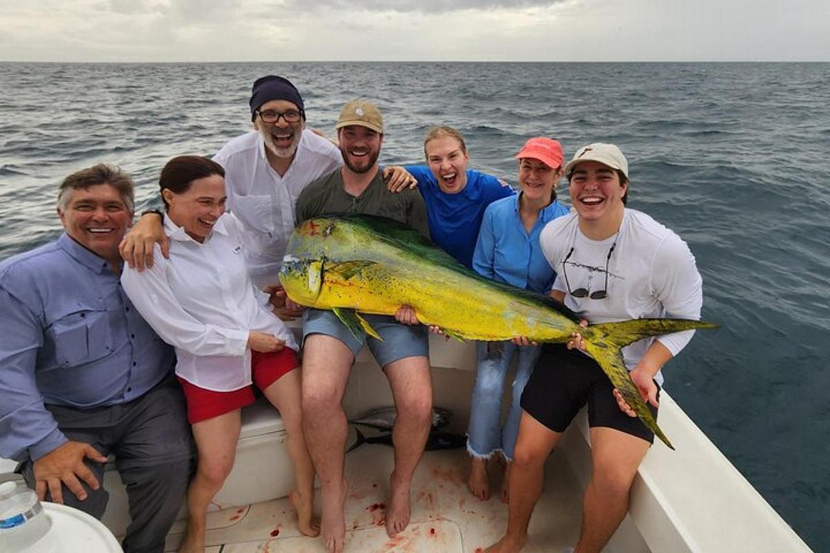 a group of people on a boat with a large fish
