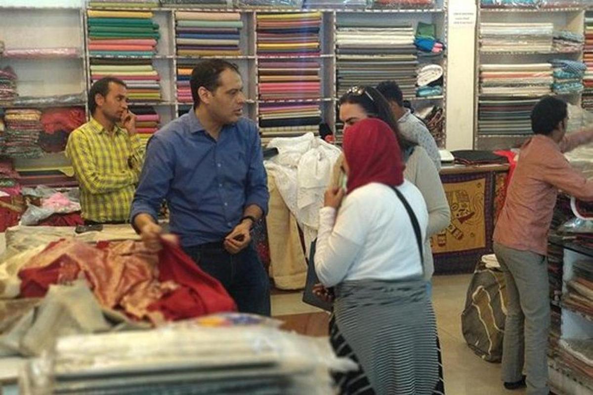 a group of people standing in a clothing store