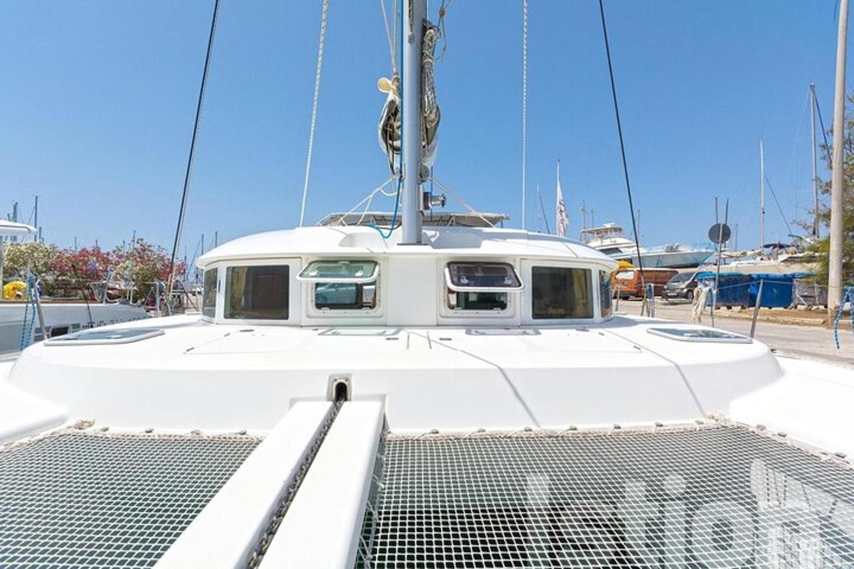 a white boat is docked in a marina