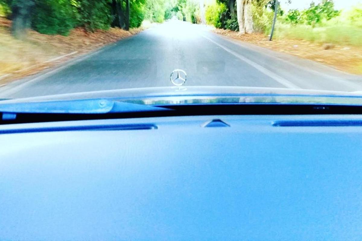 a view from the windshield of a car driving down a road