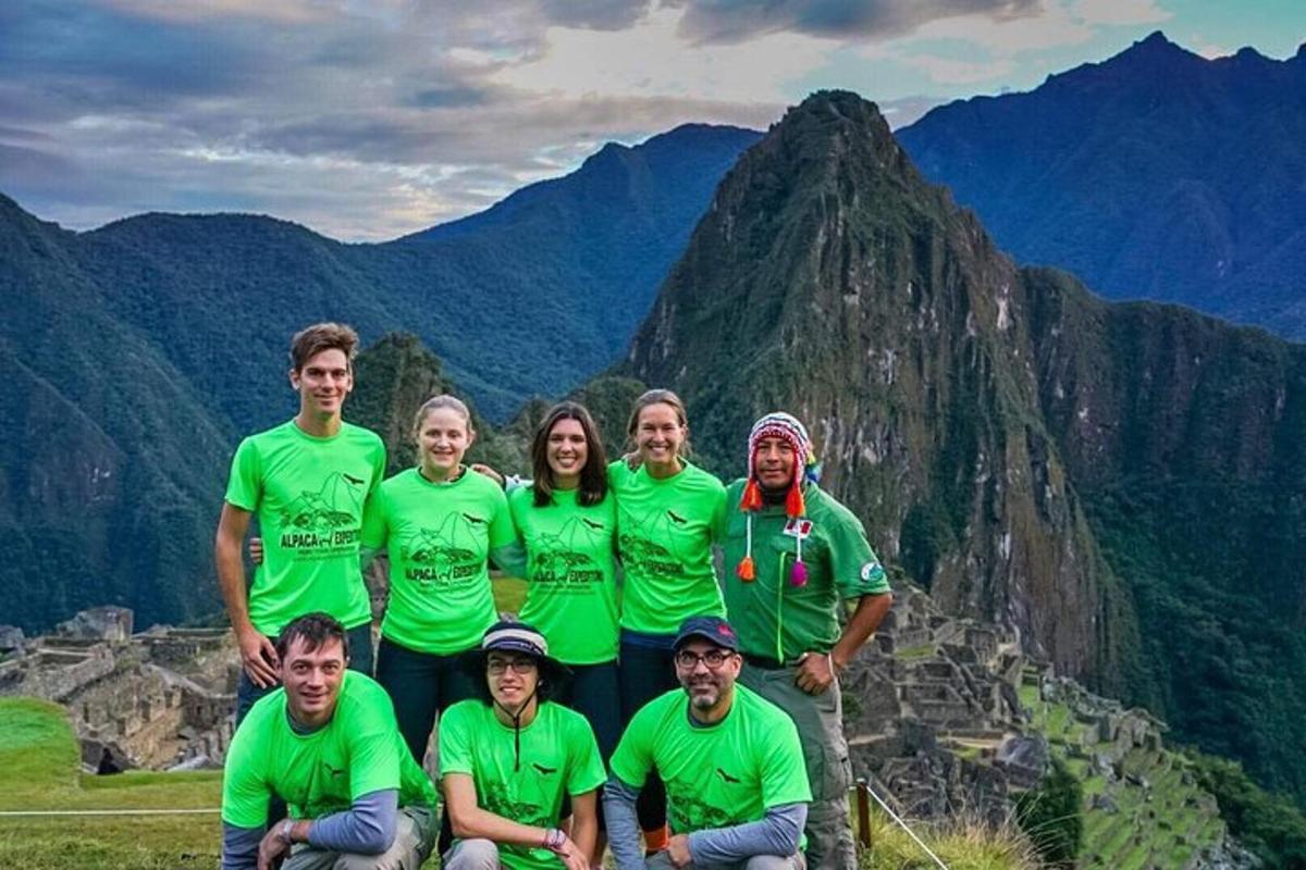 a group of people posing for a picture on a mountain