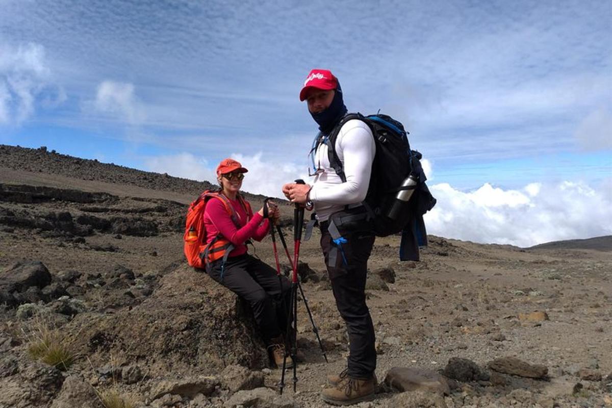 a man and a woman standing on a mountain