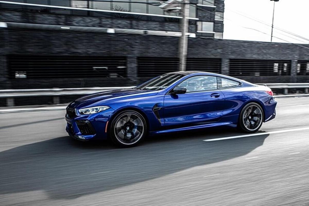 a blue car is driving down a street