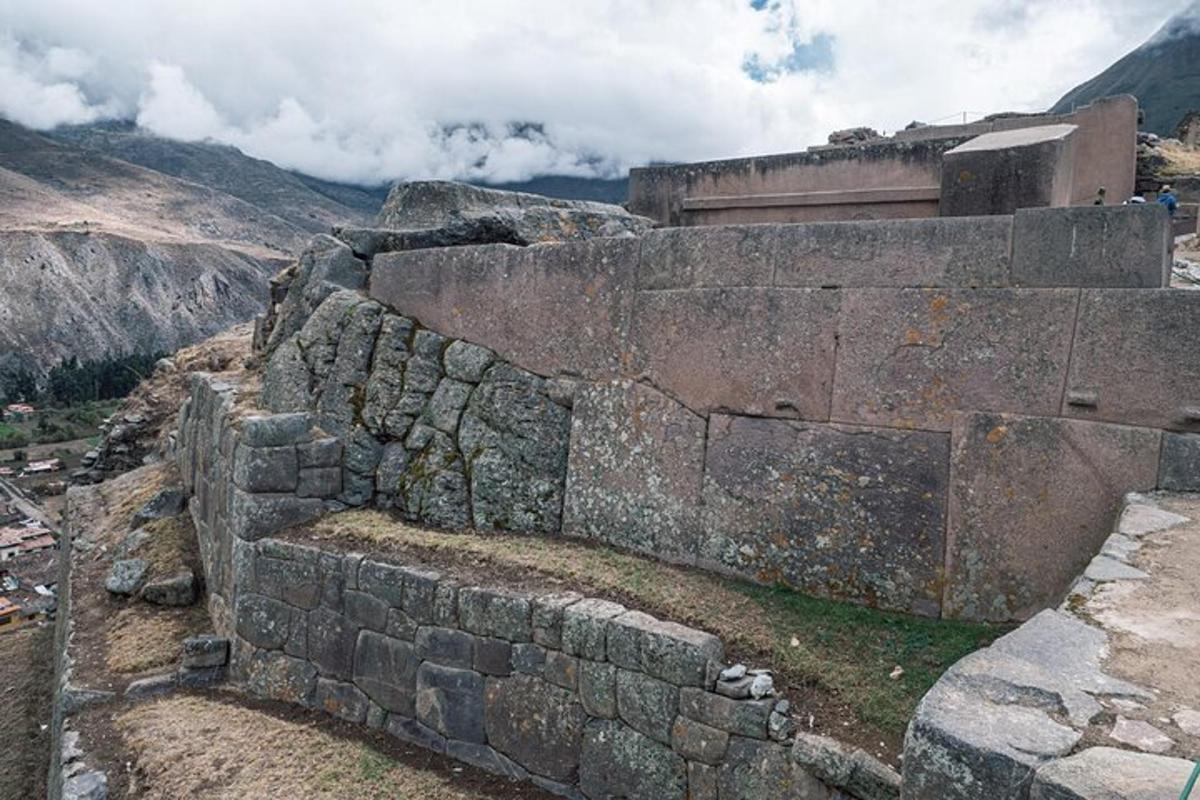 an old stone wall on top of a mountain