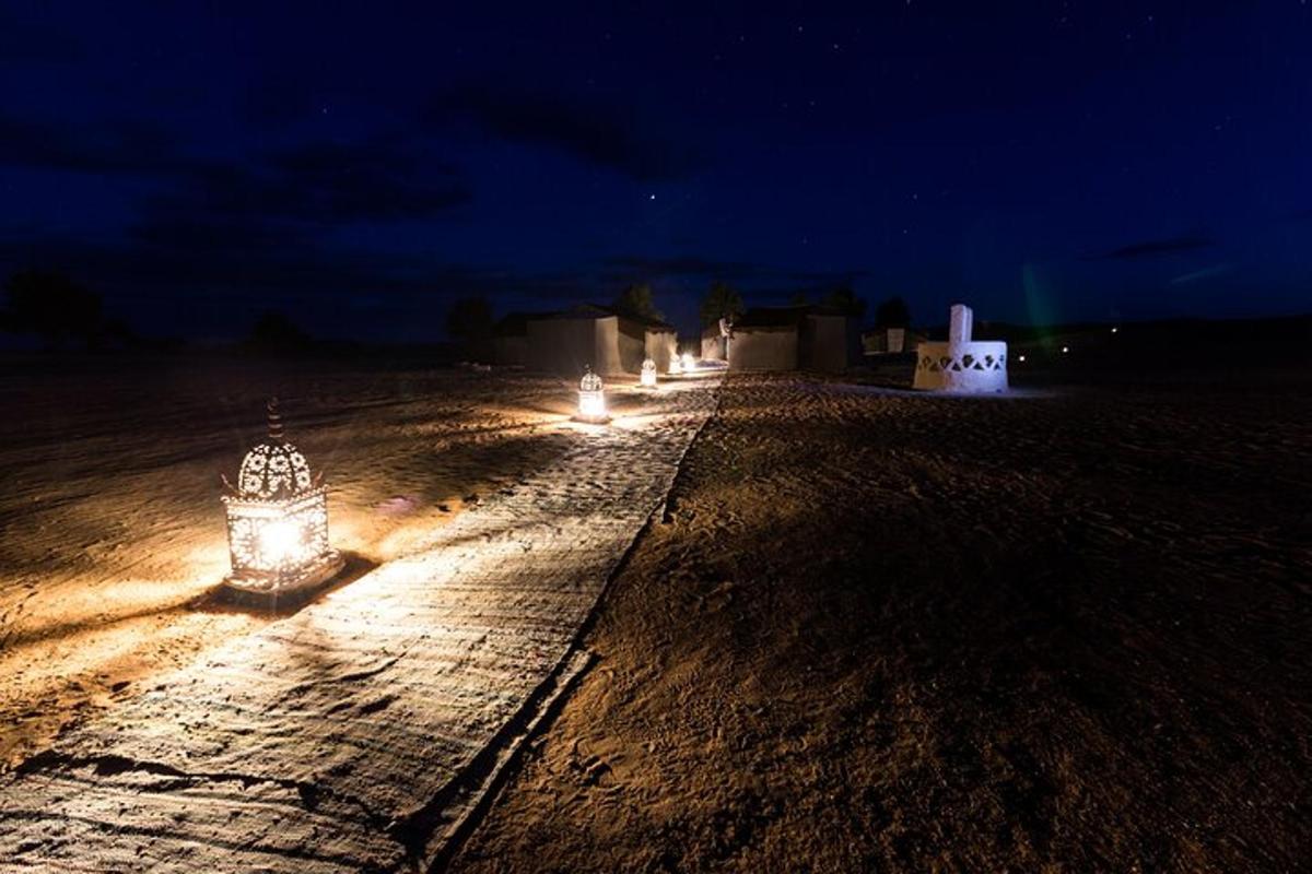 a row of lights on a beach at night