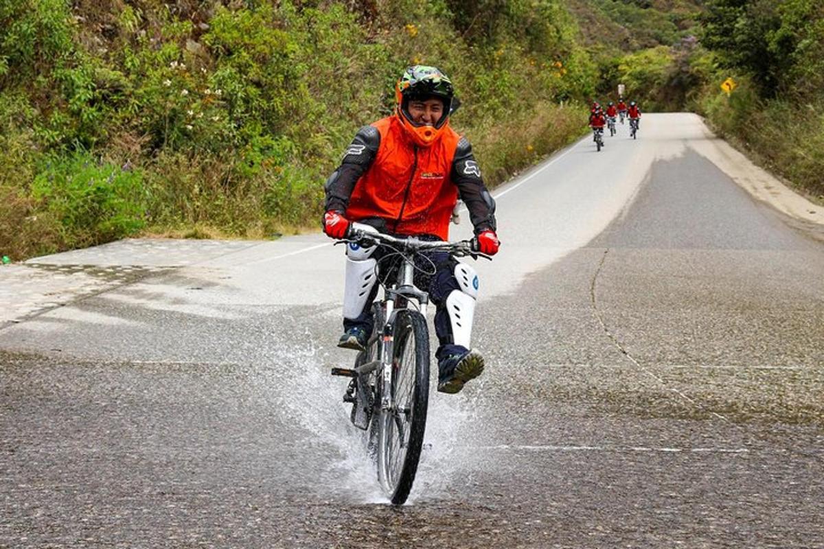 a man riding a bike down a road