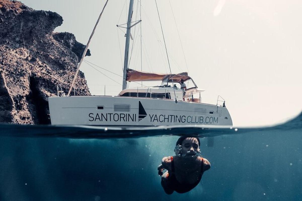 a person swimming in the water in front of a boat