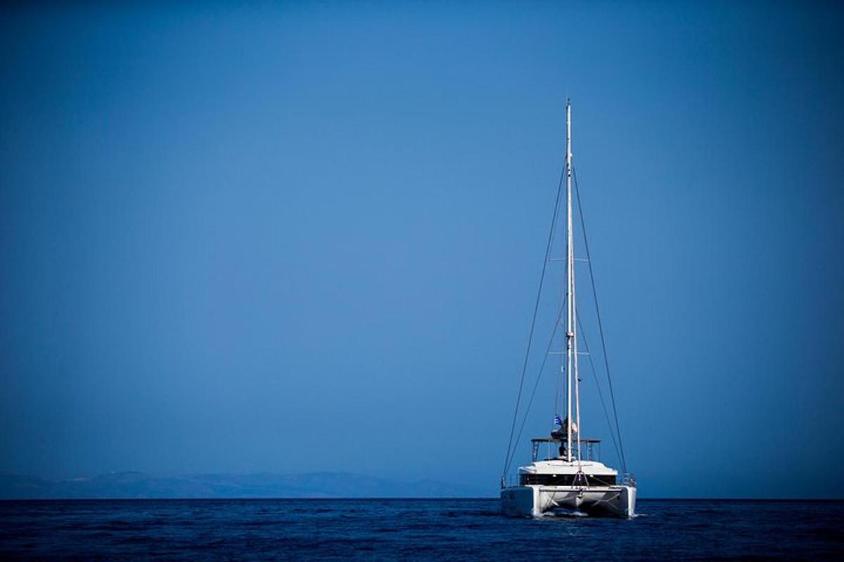 a white boat floating in the middle of the ocean