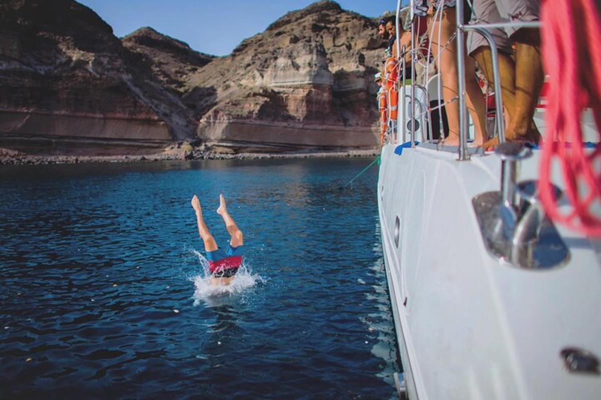 a person diving into the water from a boat