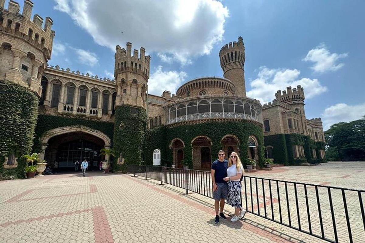 a man and woman standing in front of a castle