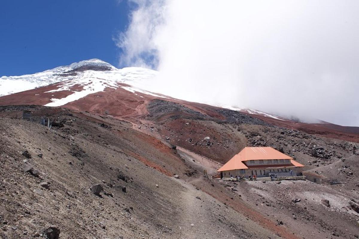a building on the side of a snow covered mountain