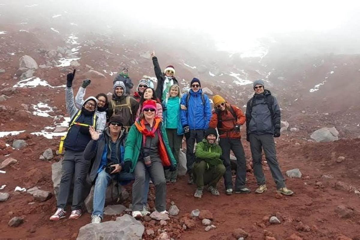 a group of people standing on top of a mountain