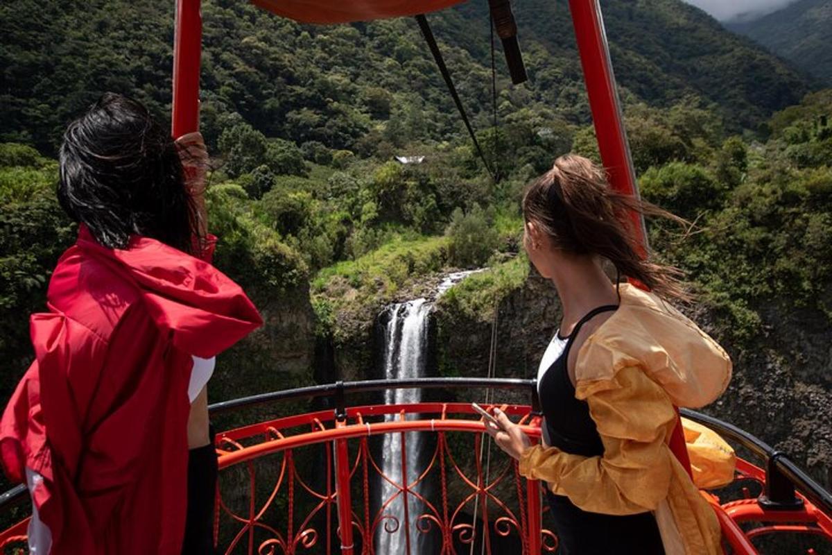 two women on a gondola looking at a waterfall