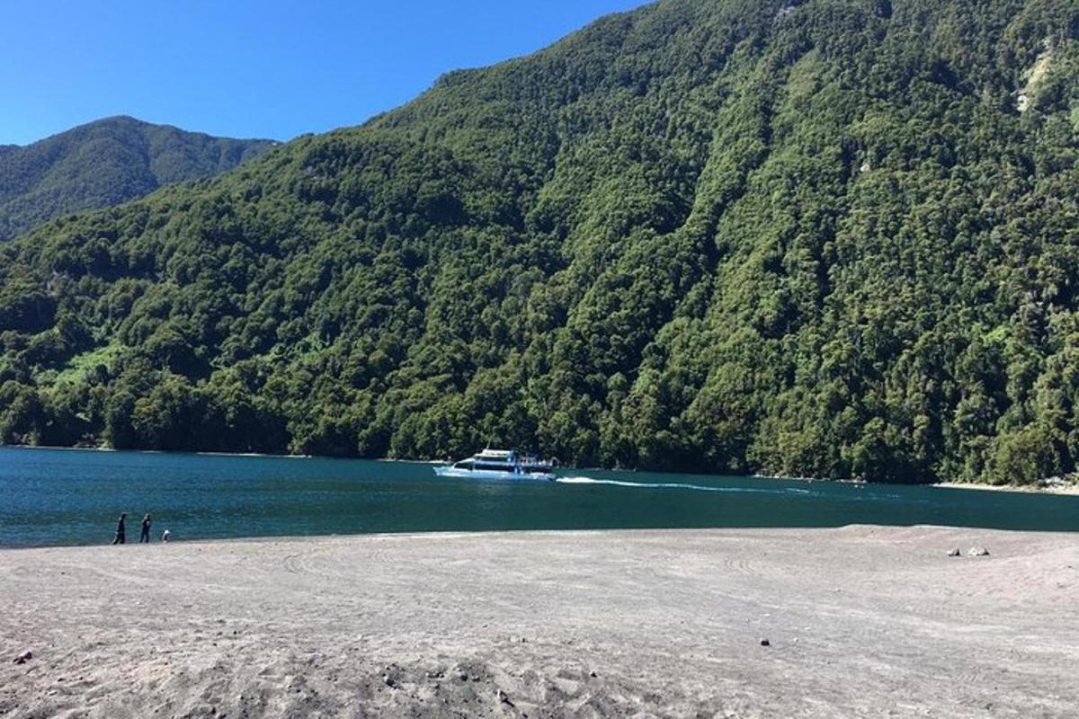 a boat on a lake with a mountain