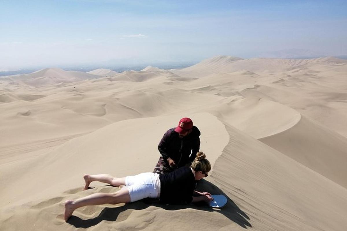 two people on the sand in the desert