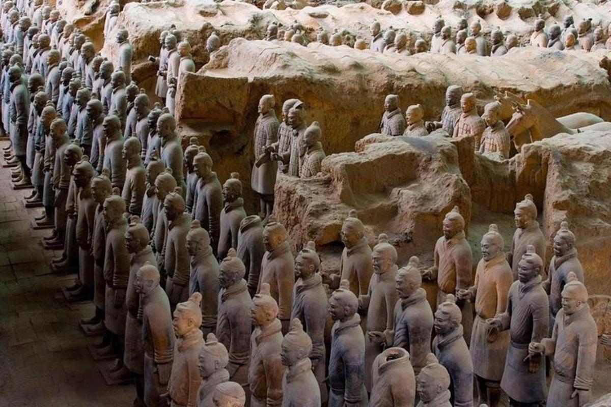 a large group of statues of people in a cave