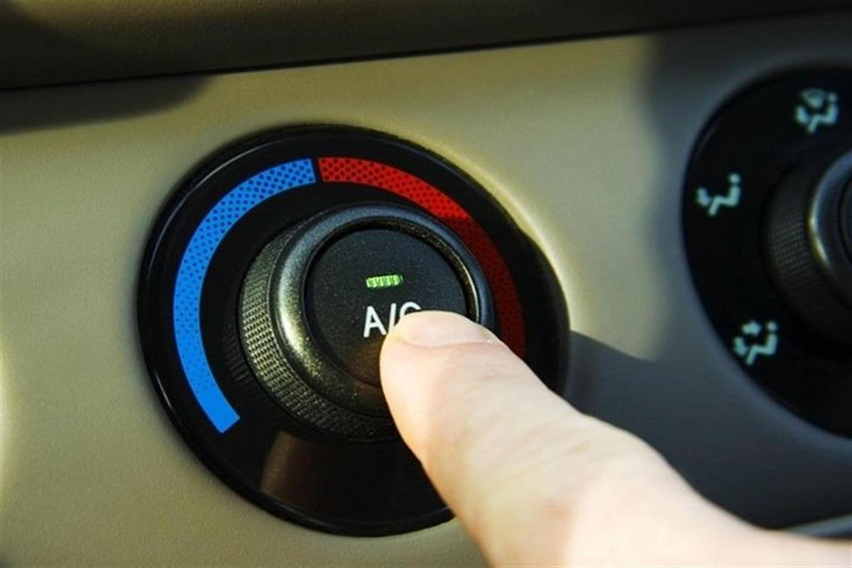 a persons index finger pushing a car button