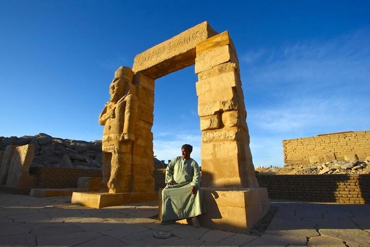 a man sitting in front of an arch