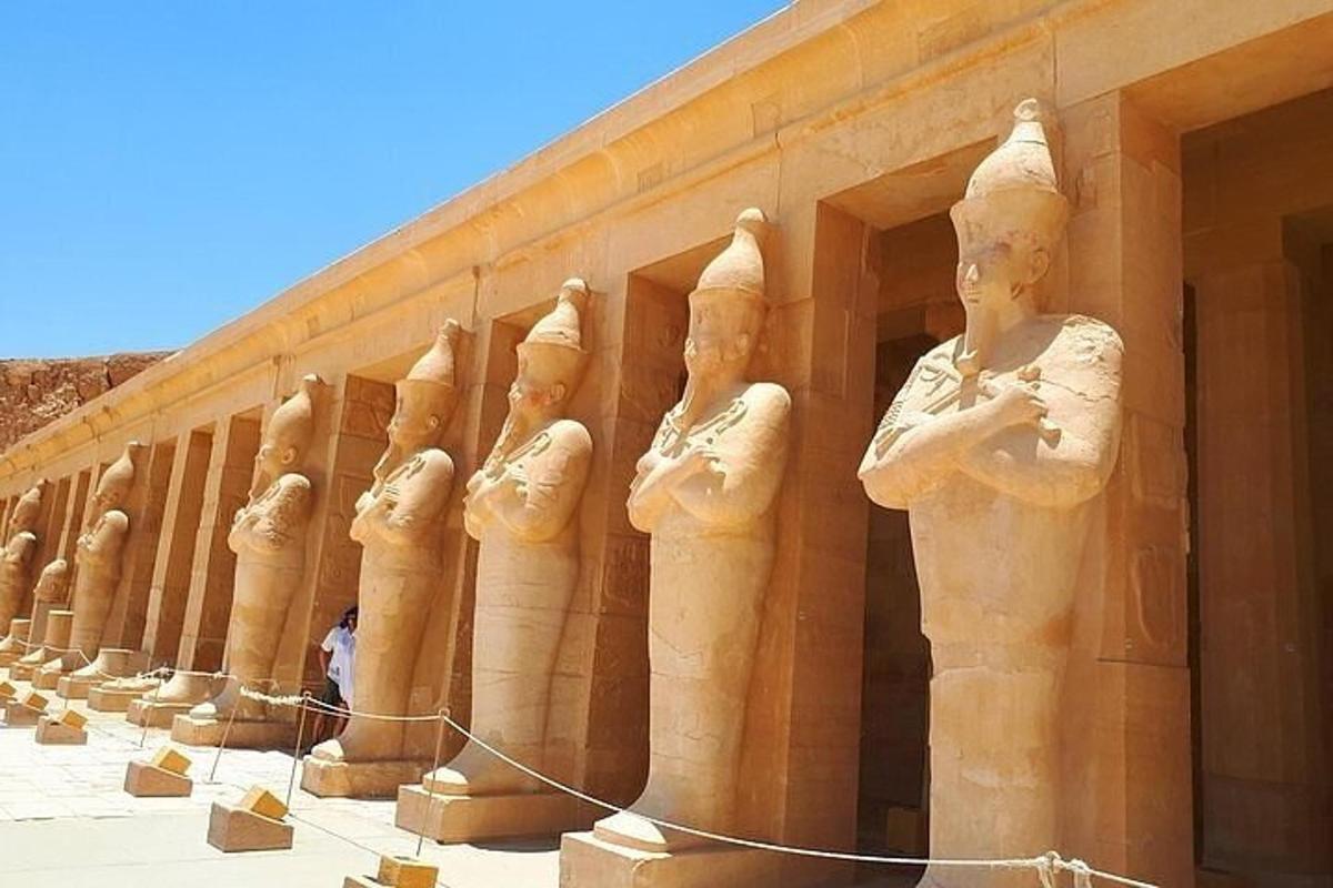 a row of statues on the side of a building