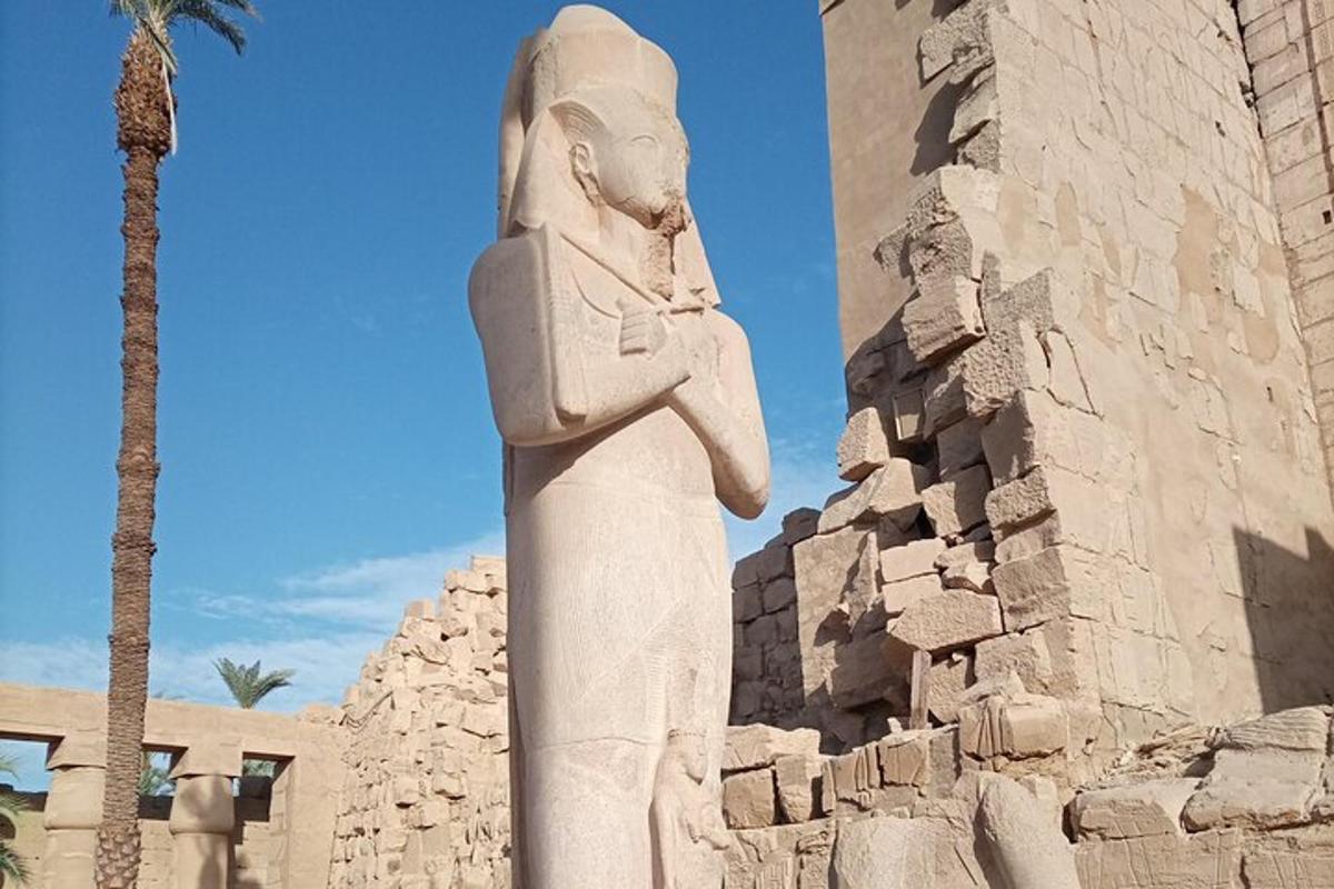 a statue of aaraoh standing in front of a building