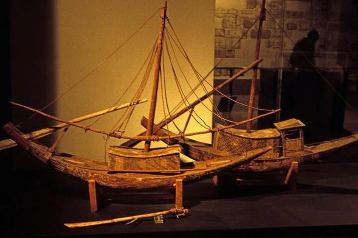 a wooden boat on display in a room