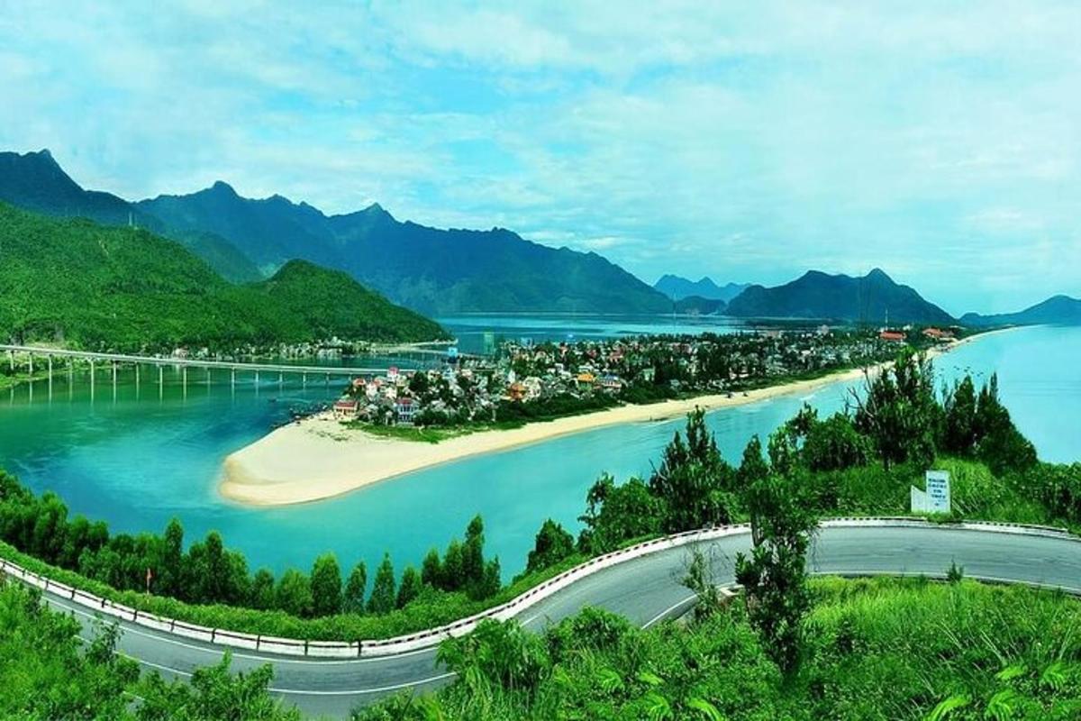 an island in a body of water with mountains in the background